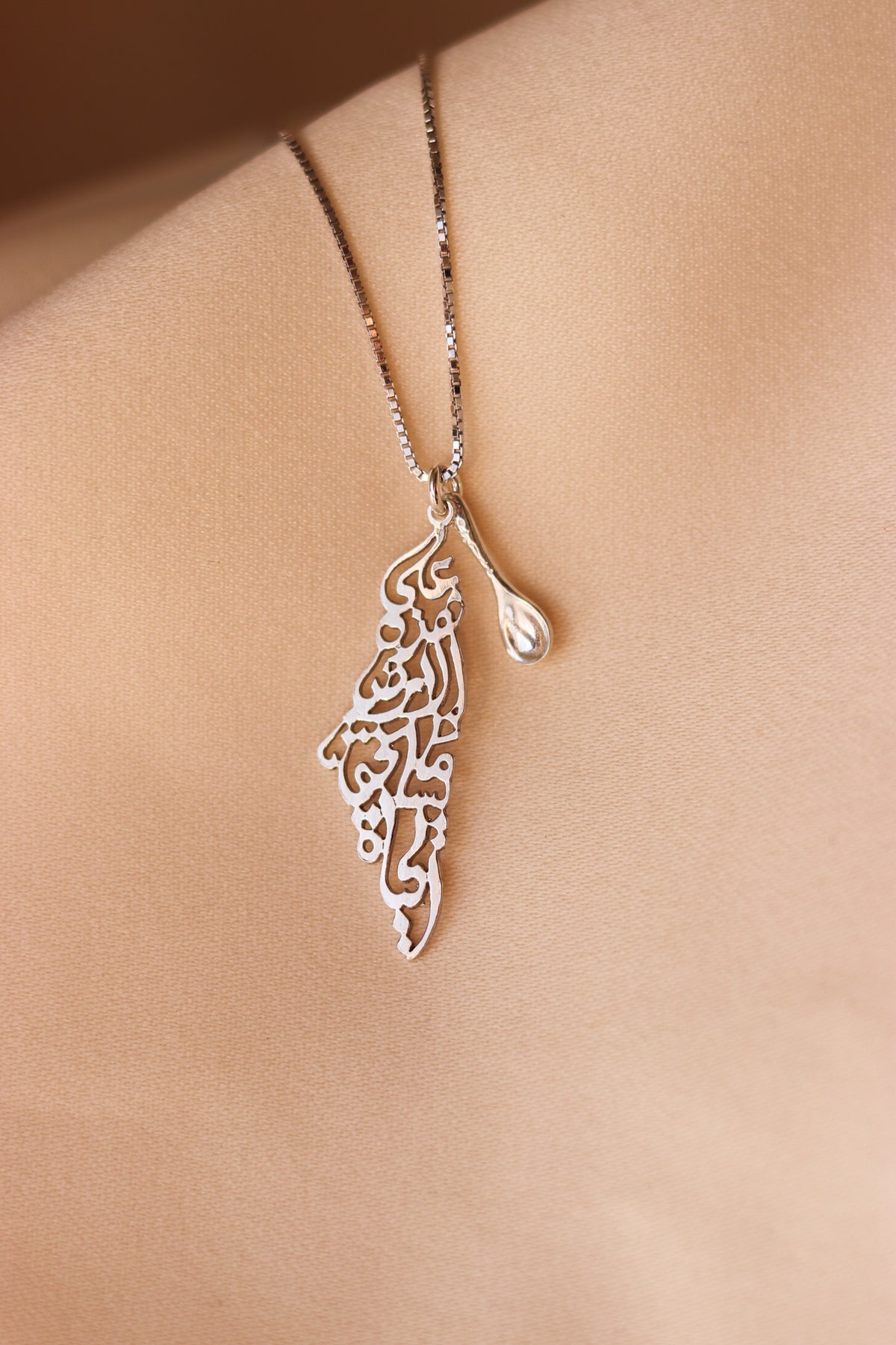 Palestine map with Palestinian famous poem written inside necklace with a symbolic spoon
